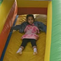 <p>A girl rides the inflatable slide at Sunday&#x27;s Cupcake Festival.</p>