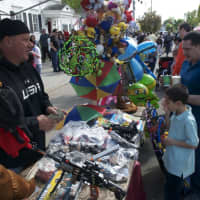 <p>A boy and his dad check out goods at Sunday&#x27;s Cupcake Festival.</p>