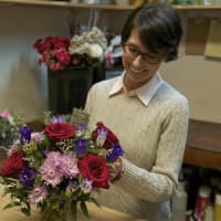 <p>Courtney Sedor works on a floral arrangement in her Beacon shop.</p>