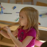 <p>A young girl explores in the music room at Grace Farms. </p>