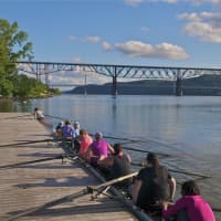 <p>Rowers get set to leave the dock on an eight-man shell.</p>
