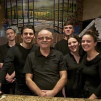 <p>Luigi Rukaj (center) with family and staff from Luigi&#x27;s Italian Restaurant in Carmel.</p>