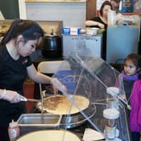 <p>A family waits for crepes at Sunday&#x27;s Chocolate Expo.</p>