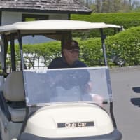 <p>A golfer gets behind the wheel and gets ready to hit the course at the Ridgefield Golf Course.</p>