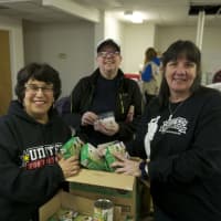 <p>Volunteers work on care packages Friday night in Carmel for Operation Cupid.</p>