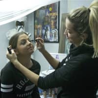 <p>Laura Rudovic does makeup for a client at her Carmel boutique.</p>