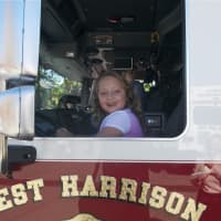 <p>A young girl sits in a fire truck at Sunday&#x27;s Harrison Police Department Open House.</p>