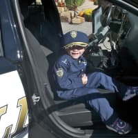 <p>A boy who came dressed for the police open house.</p>