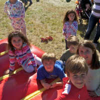<p>Kids check out the bouncy house area at Harvest Fest.</p>