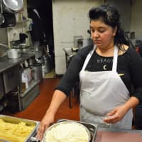 <p>Rosa Reyes of Hawthorne makes arancini - stuffed rice balls covered with breadcrumbs - in the kitchen at Italian Riviera.</p>