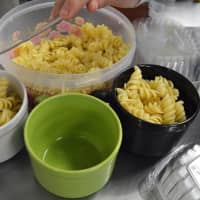 <p>Prepping pasta meals for school lunches.</p>
