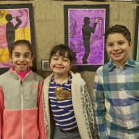 <p>From left: Brooke Neigler, 8, Taylor Coroni, 7, and Blake Cortell, 7, stand in front of their work.</p>