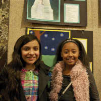 <p>Melani Carias, 11, and Heaven Robinson, 11, both of Stamford, with their artwork.</p>