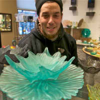 <p>Glass caster Jacob Searles of Beacon - one of over 40 artists whose work can be found at the gallery - with some of his work at Hudson Beach Glass.</p>