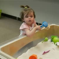 <p>A girl plays in a sandbox at the Everwonder Children&#x27;s Museum.</p>