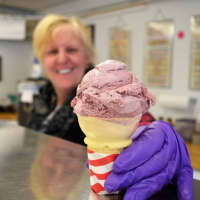 <p>Theresa Brown of Clifton holds a cone of raspberry Nelson&#x27;s Dutch Farms Ice Cream at the Whistle Stop.</p>