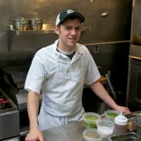 <p>Chef/owner Brian Arnoff at work in his kitchen at Kitchen Sink Food &amp; Drink.</p>