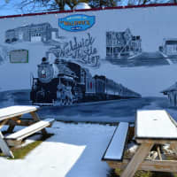 <p>The picnic area along the side of the Whistle Stop, which also features a train mural.</p>