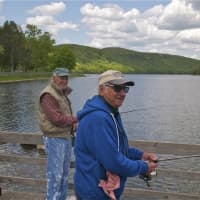 <p>Two fishermen at Squantz Pond State Park in New Fairfield</p>