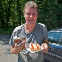 <p>A satisfied customer grabs a couple of dogs.</p>