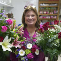 <p>Victoria Morrow of the Village Flower Shop with roses and other Valentine&#x27;s Day arrangements.</p>