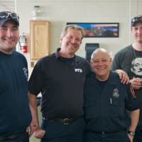 <p>Poughkeepsie firefighter Mike Marinucci (center) got a warm sendoff from his fellow firemen Thursday in Poughkeepsie.</p>
