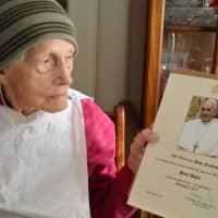 <p>Holding the apostolic blessing from Pope Francis, sent to Helen Boyle on her 100th birthday.</p>