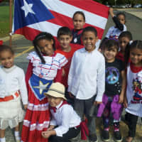 <p>Students from the Julian Curtiss School, representing 60 countries and speaking 30 languages, celebrate U.N. Day on Thursday.</p>