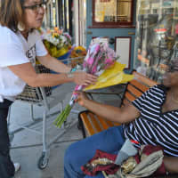 <p>Tyrrells Floral Designer Lisa Mayfield, left, giving out free bouquets in Westwood.</p>
