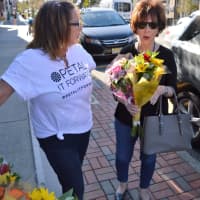 <p>Tyrrells Floral Designer Lisa Mayfield, left, giving out free bouquets in Westwood.</p>
