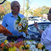 <p>Tyrrells Floral Designer Lisa Mayfield, right, giving out free bouquets in Westwood.</p>