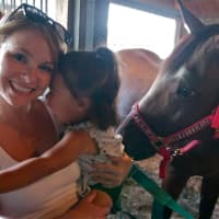<p>A horse turns its head, scaring this little girl at the Dutchess County Fair.</p>