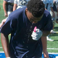 <p>Lourdes players cool off after a practice.</p>