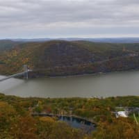 <p>State police said Monday that items found where someone jumped from the Bear Mountain Bridge on Sunday (as seen here in the fall from Perkins Drive) tentatively ID the jumper as a 27-year-old Rockland man,.An underwater search for the body continues.</p>