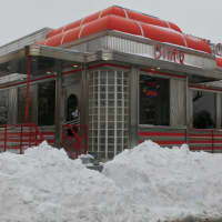 <p>Snowbanks have a path cleared to the landmark Yankee Clipper Diner.</p>