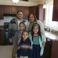 <p>Jeymar and Kimberly Soto, with twins Jeymar and Jeydalis, 9, and Landon (front), 6, in their new kitchen. Missing from the photo is 14-year-old Alex.</p>