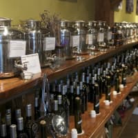 <p>Olive oil and vinegar line the shelves at The Blue Olive.</p>