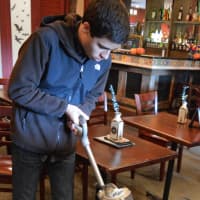 <p>Jonathan Yammerino vacuuming at the Blue Moon Mexican Cafe.</p>