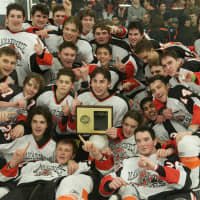 <p>Mamaroneck poses with the Section 1 championship trophy Sunday after beating Suffern at the Brewster Ice Arena.</p>