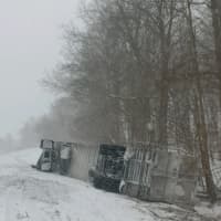 <p>Crews are working Friday morning to remove this tractor-trailer that crashed down an embankment Thursday during the height of the storm.</p>