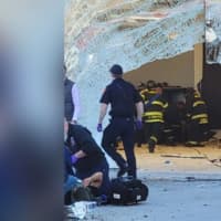 <p>Crews on the scene of a car that crashed through the window of the Apple Store at the Derby Street Shops in Hingham.</p>