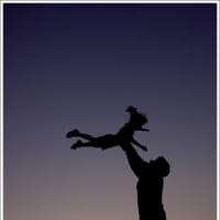 <p>A father tosses he daughter toward the sky.</p>