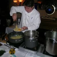 <p>John Carollo, Del&#x27;Arte&#x27;s owner and chef, whips up a dish tableside at the Orangeburg restaurant.</p>