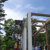 <p>Curtain Call designers and performers erect the stage for Shakespeare on the Green in Stamford.</p>