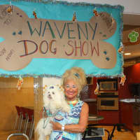 <p>A woman holds her dog at the show.</p>