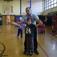 <p>Amazing Grace Circus Creative Director Carlo Pellegrini, also known as “Mr. Amazing,” helped a second-grader with diabolo manipulation.</p>