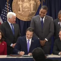 <p>New York Gov. Andrew Cuomo signing the bill.</p>