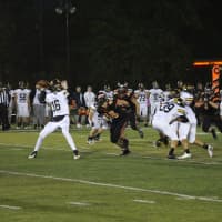 <p>Cresskill quarterback Jack Maltby looks to pass down field as Jordan Wexler bears down on him early in the game.</p>