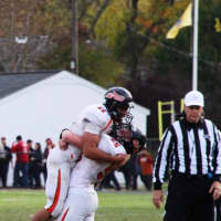 <p>Dylan grabs quarterback Frank Quattrone in a joyous bear hug after winning the first NJIC Championship against Pompton Lakes.</p>