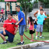 <p>Children were able to get the feel of a real fire hose at National Night Out.</p>